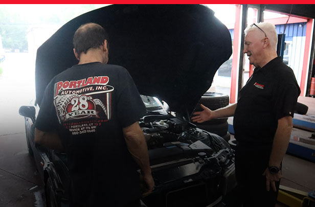 Staff Performing Diagnostics on Car with Hood Open | Portland Automotive